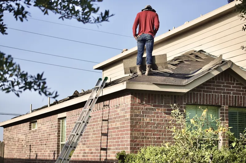 Professional roofer working on a residential roof in Country Meadows